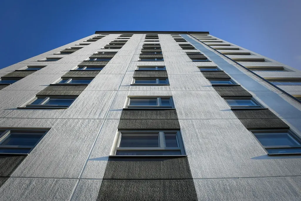 white concrete building with black metal cross